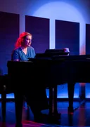 Grace plays the piano as Cathy in The Last Five Years.